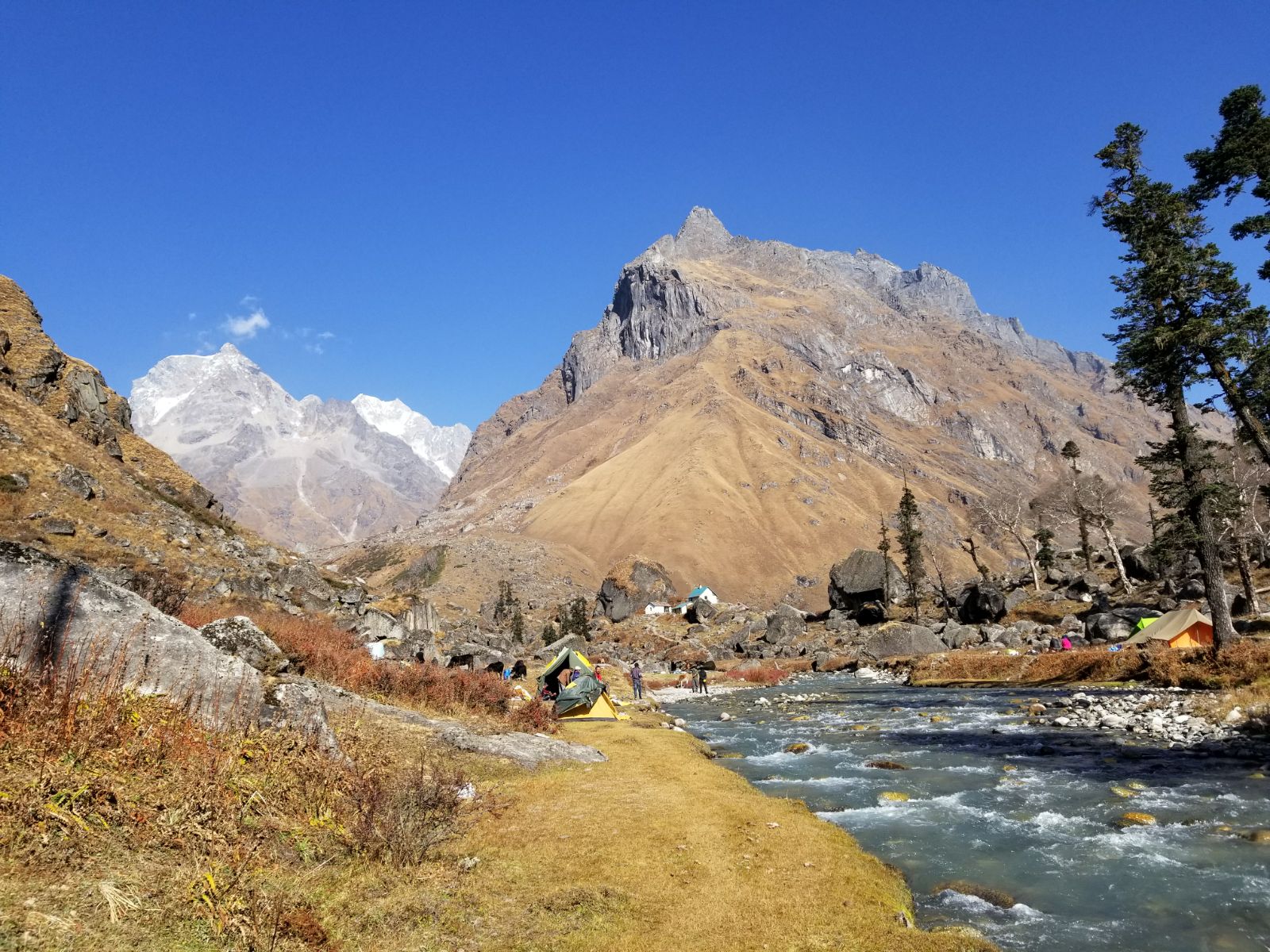 The river s song matches the beauty of the mountains. Har Ki Doon peak right Hata peak left - Himalayan Institute