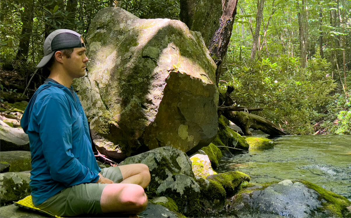great smoky mountains excursions meditating by creek inline - Himalayan Institute
